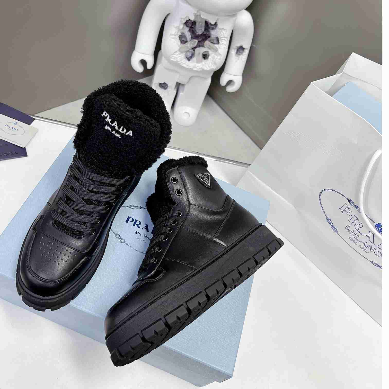 Prada Leather And Shearling High-top Sneakers - DopestKickz